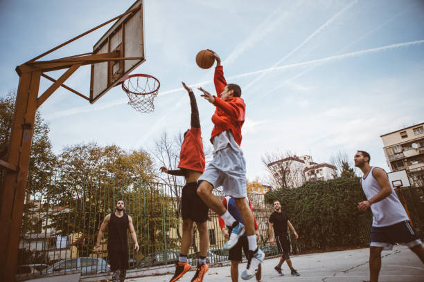 Group of men playing basketball at the local park